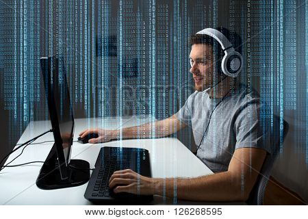 technology, gaming, entertainment, let's play and people concept - happy young man in headset with pc computer playing game at home and streaming playthrough or walkthrough video