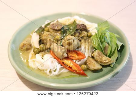 Curry chicken noodles (KHANOM CHIN) with vegetable.