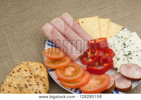 Breakfast on the table. Ham, tomato and cheese for breakfast with bread. Homemade healthy food. Vegetables and ham for breakfast.