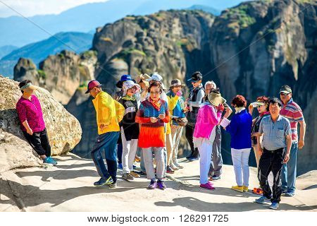 KALABAKA, GREECE - CIRCA JUNE 2015: Korean group of tourists visit Meteory monasteries in Kalabaka village in Greece