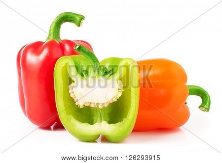red green orange bell peppers with half isolated on white.