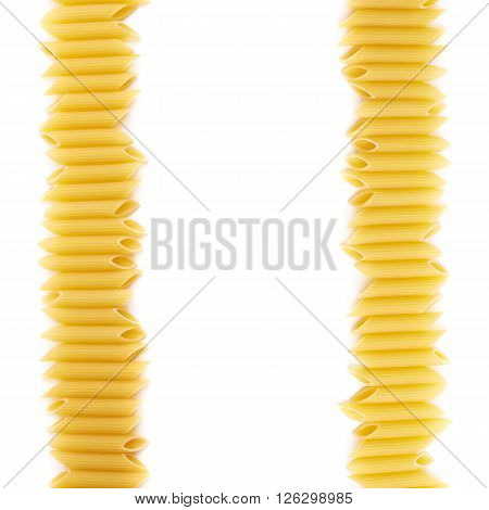 Dried penne pasta copyspace and empty for your text background composition over the white surface