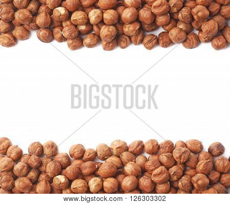Copyspace background composition with the borders made of hazelnuts isolated over the white background