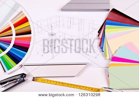 construction and architectural design concept. 3D visualization of the kitchen project under construction with wooden and plastic panels, color palette and a tape measure on a blurry figures.