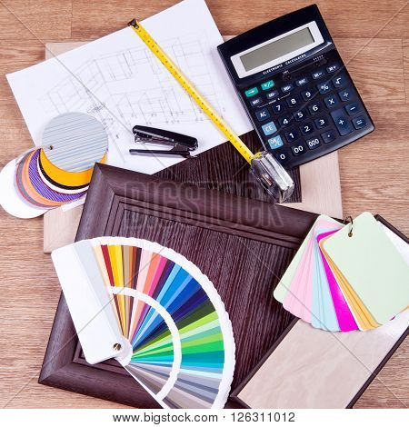 construction and architectural design concept. 3D visualization of the kitchen project under construction with wooden and plastic panels, a calculator and a color palette on the blurry figures.