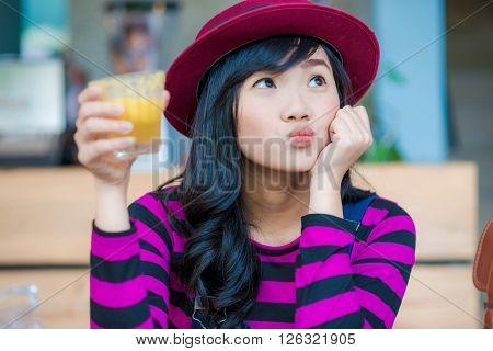 Young Asian Beautiful Woman Drinking Fresh Orange Juice