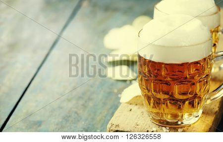 Beer and Potato Chips on vintage wooden table