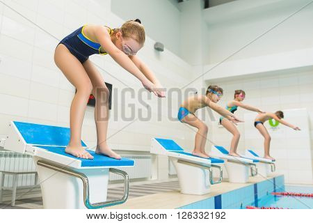 children ready to jump into sport swimming pool. Sporty kids.