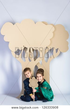 Love concept. Couple of kids. boy and girl with  cardboard trees.
