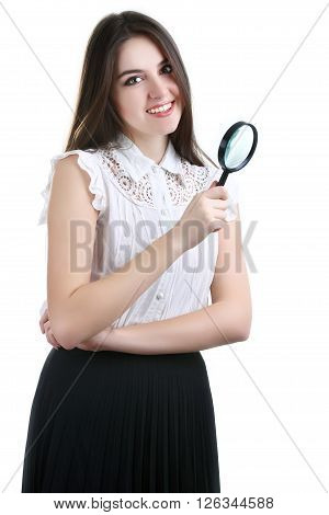 Beautiful girl portrait looking through magnifier. isolated on white