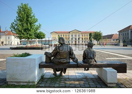 ALBA IULIA, ROMANIA - AUGUST 121, 2015: old woman with veil and child bronze group sculpture in Fortress Square of Carolina Citadel in Alba Iulia, Romania 