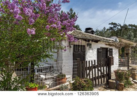 Old stone house and violet flowers in village of Aliki, Thassos island, East Macedonia and Thrace, Greece