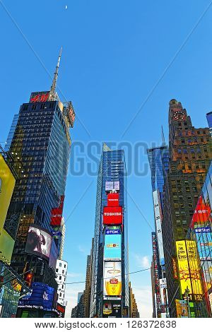 NEW YORK USA - APRIL 26 2015: 7th Avenue and Broadway skyscrapers in Midtown Manhattan New York USA. It is called Times Square. It is a commercial junction of Broadway and 7th Avenue.