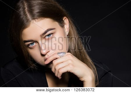 Portrait of a girl with diamonds on black dackground.