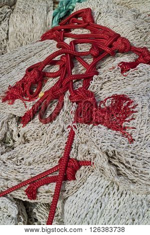 Pile of fishing nets and red chord 