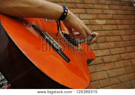 Man playing guitar enoying the acoustic sound