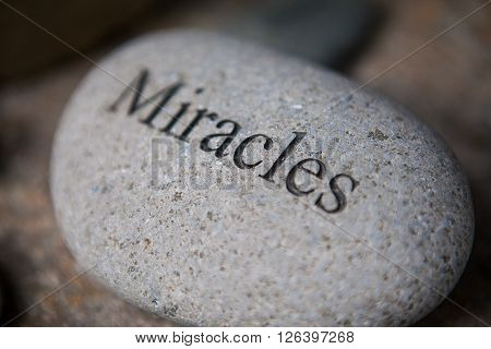 pebble with engraved message miracles. Inspirational stones
** Note: Shallow depth of field