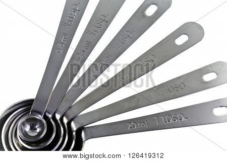 Set of stainless steel measuring spoons in varying sizes used to measure an amount of an ingredient either liquid or dry when cooking.