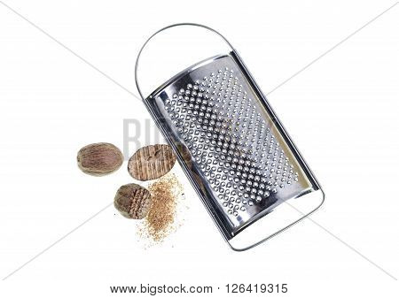 Nutmeg grated nutmeg and fine grater on white background.