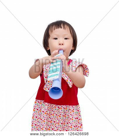 Little asian girl playing trumpet toy over white