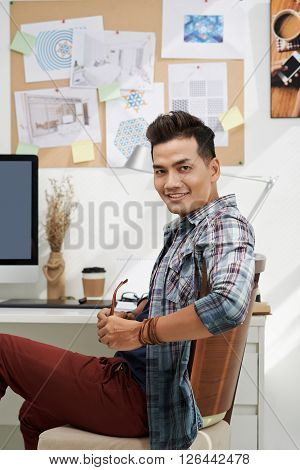 Smiling interior designer working in hies studio