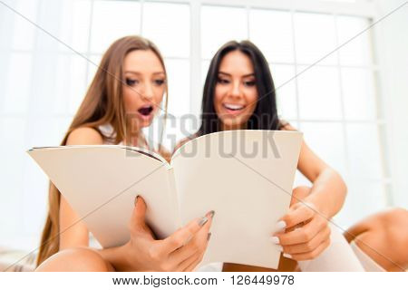 Wow! Two Pretty Girlfriends Reading Smth Interesting In Journal