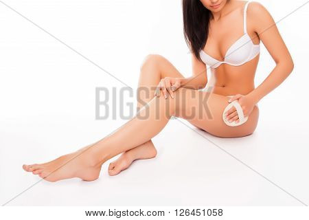 Pretty Young Woman Doing Peeling Massage For Legs