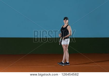 Woman In Sportswear Serves Tennis Ball