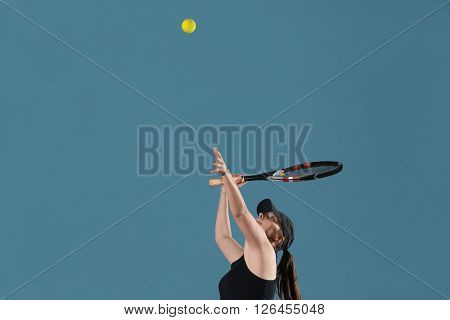 Young Female Ready To Serves Toss Ball
