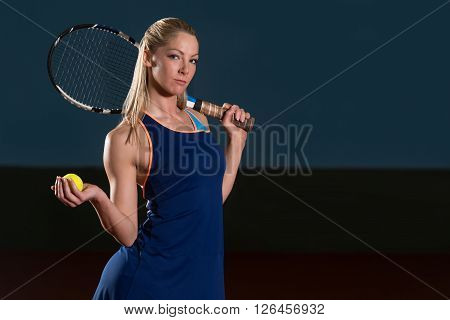 Woman Keeps Tennis Racket And Ball On Shoulders