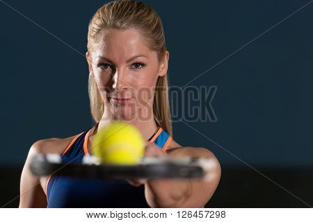 Young Woman Holding Racket With Ball