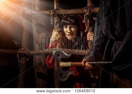 Beautiful Witch In Red Dress In The Dungeon Is Looking On The Sunray.
