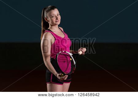 Female Tennis Player With A Racket Indoors