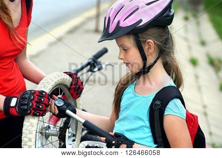 Girls children cycling Family pump up bicycle tire.
