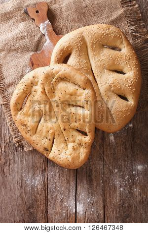 Fugasse French Bread Closeup On The Table. Vertical Top View, Rustic