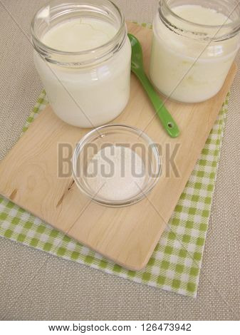 Natural yogurt in jars with inulin powder