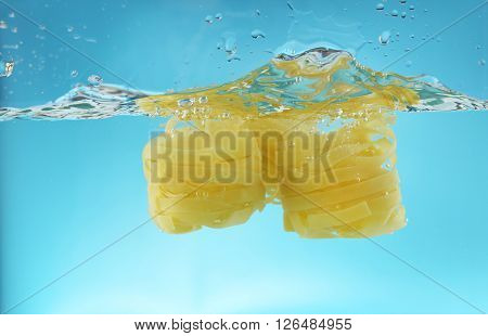 Falling pasta in water