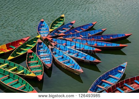 Colorful small boats on Phewa Lake in Pokhara, Nepal
