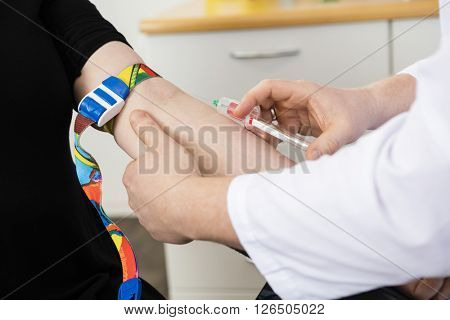 Cropped Image Of Male Doctor Collecting Blood From Patient