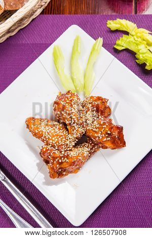 chicken meat is barbecue with sesame on white plate