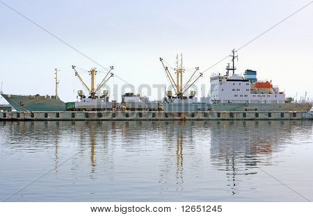 ship on a berth in port loading/unloading 
 - See similar images of this series in my portfolio
