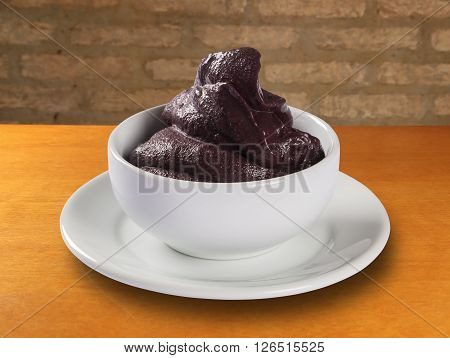 Bowl of fresh Brazilian acai. Wood background