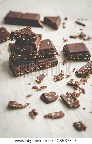 Chocolate bar and pices on wooden table. Selective focus vintage style