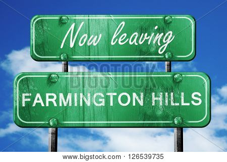 Now leaving farmington hills road sign with blue sky