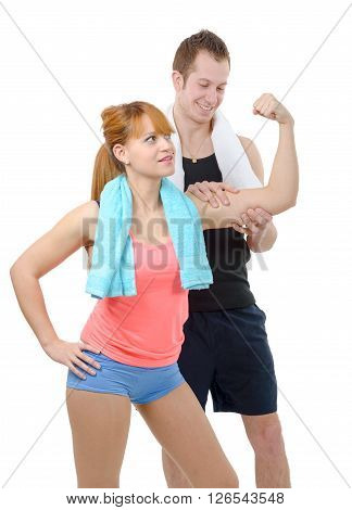 young man looks at biceps of his girlfriend on white background