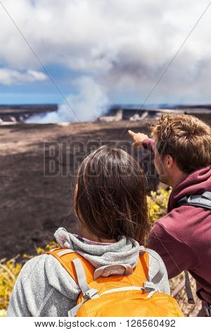 Hawaii scene. Hiking people looking at Hawaiian volcano: Halemaumau crater within the Kilauea Volcano caldera in Hawaii volcanoes national park on Big Island.