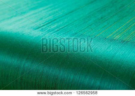 Green silk on a warping loom of a textile mill Silk for weaving on a hand loom