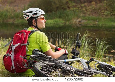 Male cyclist traveling with bike and backpack.