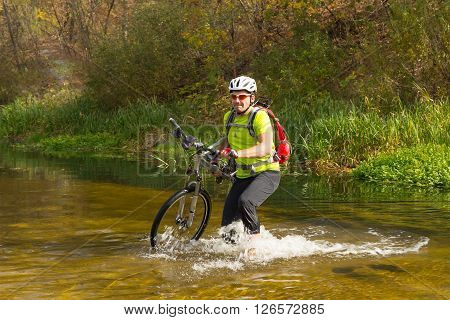 Male cyclist traveling with bike and backpack.