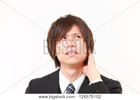 studio shot of perplexed businessman on white background